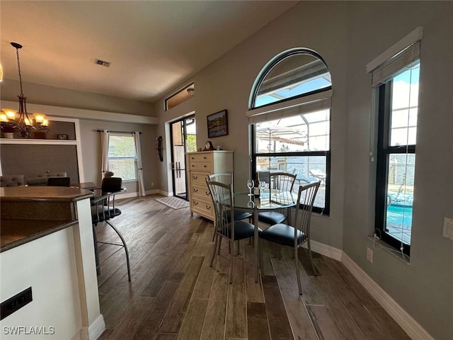 dining room featuring dark hardwood / wood-style floors and a chandelier