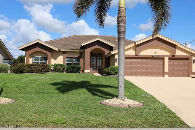 ranch-style home with french doors, a front yard, and a garage