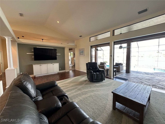 living room featuring decorative columns, ceiling fan, vaulted ceiling, and hardwood / wood-style flooring