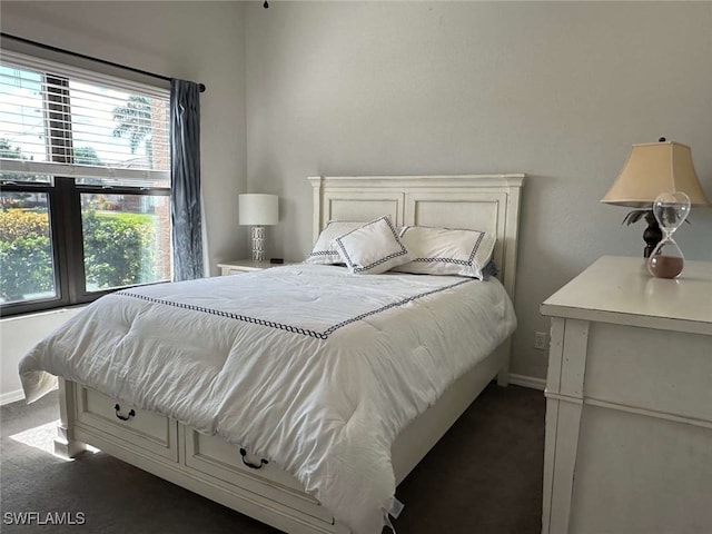 bedroom featuring dark carpet