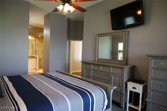 bedroom featuring ceiling fan and ensuite bath