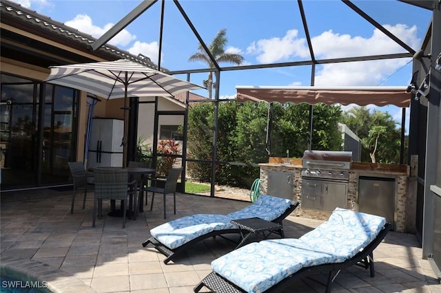 view of patio / terrace with a lanai, area for grilling, and grilling area