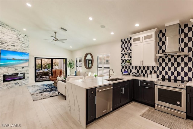 kitchen with white cabinets, stainless steel appliances, a wealth of natural light, and sink