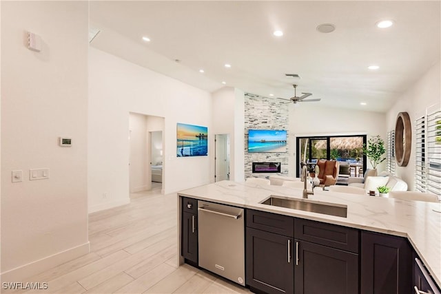 kitchen featuring dishwasher, lofted ceiling, sink, ceiling fan, and light wood-type flooring