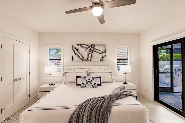 bedroom with ceiling fan, light wood-type flooring, access to outside, and multiple windows