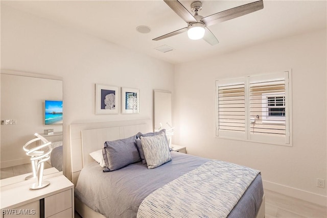 bedroom with ceiling fan and light wood-type flooring