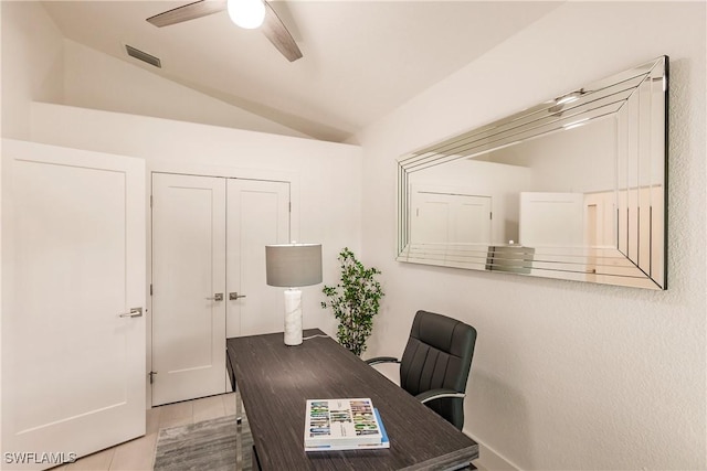 office featuring light tile patterned floors, vaulted ceiling, and ceiling fan