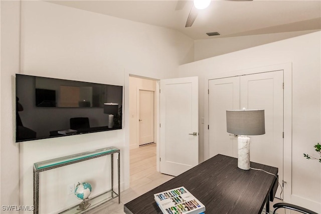 office area featuring ceiling fan, light wood-type flooring, and lofted ceiling