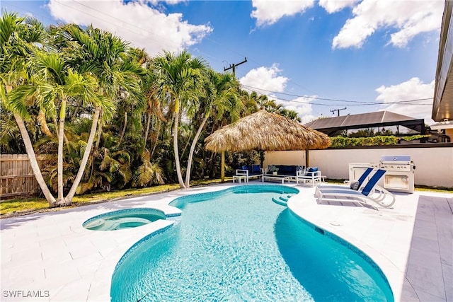 view of pool with an in ground hot tub, an outdoor hangout area, and a patio area