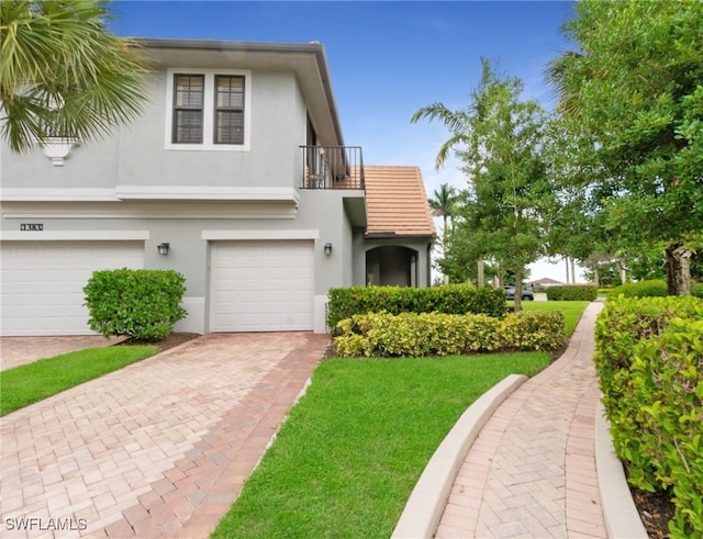 view of front of property with a garage and a balcony