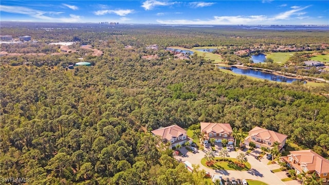 aerial view with a forest view and a water view