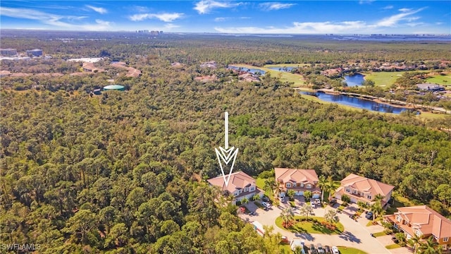 aerial view featuring a water view and a wooded view