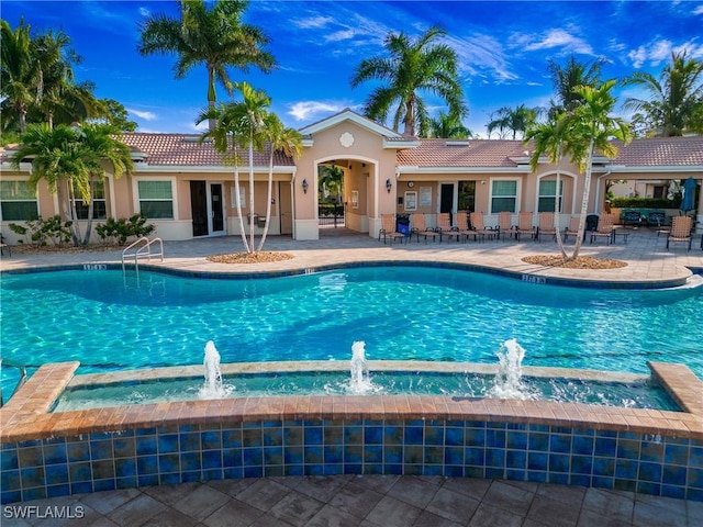 community pool with a patio area