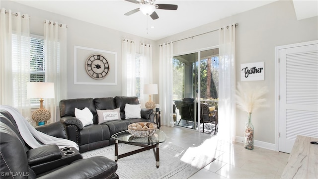 tiled living room featuring ceiling fan