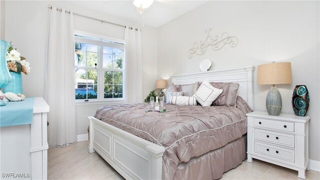 bedroom with light tile patterned floors and baseboards