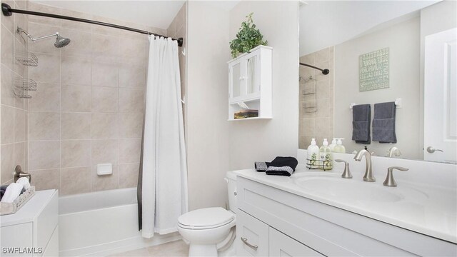 bathroom featuring toilet, tile patterned floors, shower / bath combination with curtain, and vanity