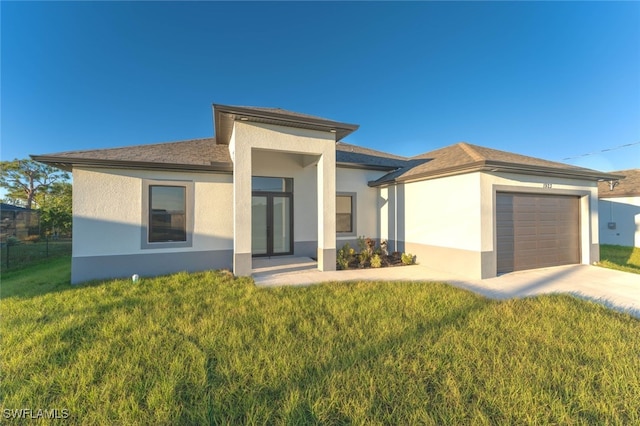 prairie-style home with a garage and a front lawn