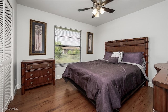 bedroom with ceiling fan, a closet, and dark wood-type flooring