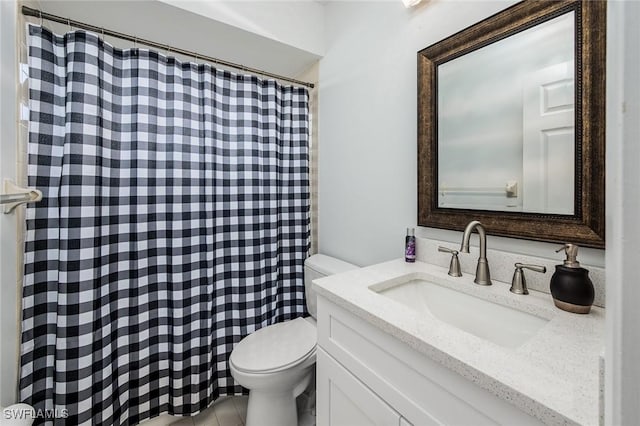 bathroom with tile patterned flooring, vanity, and toilet