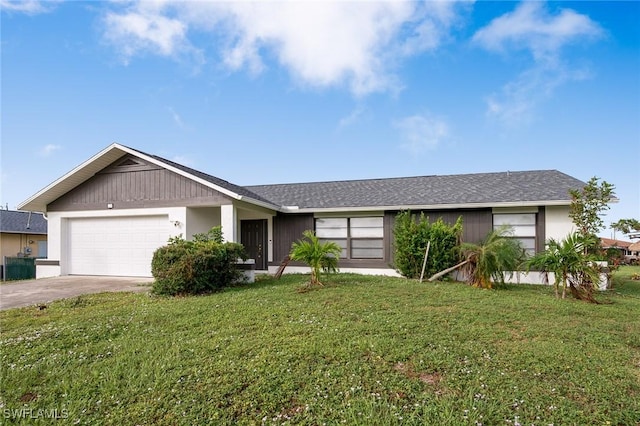 single story home with a garage and a front lawn