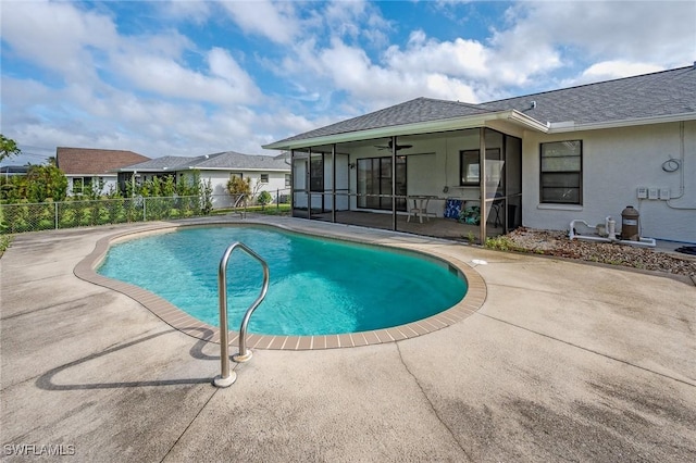 view of swimming pool featuring a patio, ceiling fan, and a sunroom