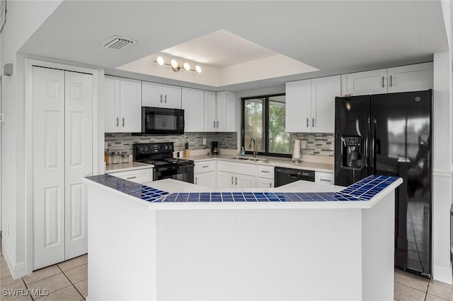 kitchen with white cabinetry, sink, light tile patterned flooring, and black appliances