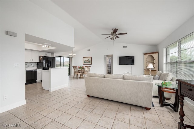 tiled living room with lofted ceiling and ceiling fan with notable chandelier