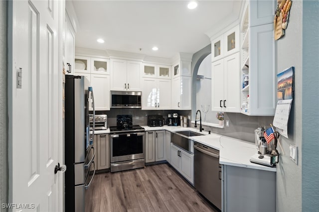 kitchen featuring white cabinets, sink, stainless steel appliances, and dark wood-type flooring