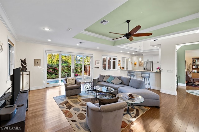 living room with french doors, hardwood / wood-style flooring, ceiling fan, and ornamental molding