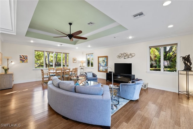 living room with plenty of natural light, ceiling fan, and light hardwood / wood-style flooring