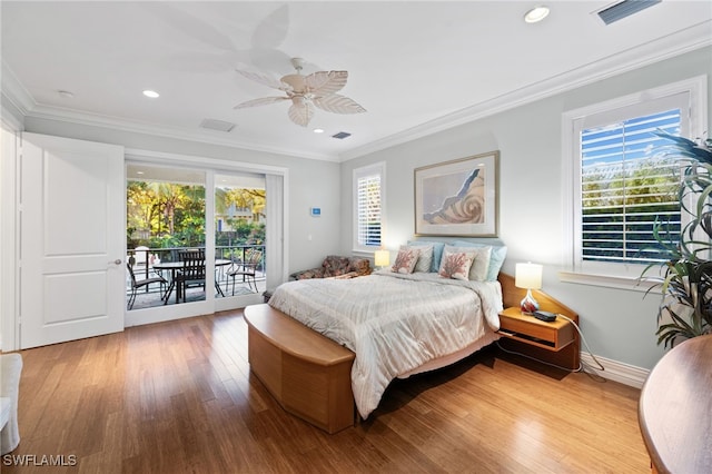 bedroom with access to outside, visible vents, wood finished floors, and ornamental molding