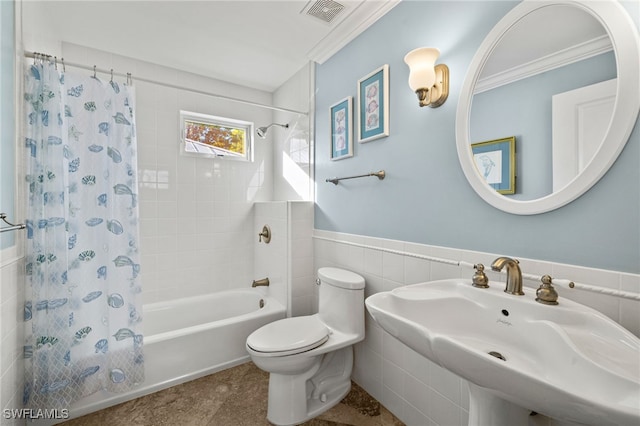 full bath featuring toilet, visible vents, tile walls, wainscoting, and shower / bath combo