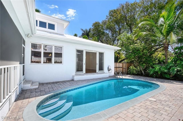 view of pool with a fenced in pool, a patio, and fence