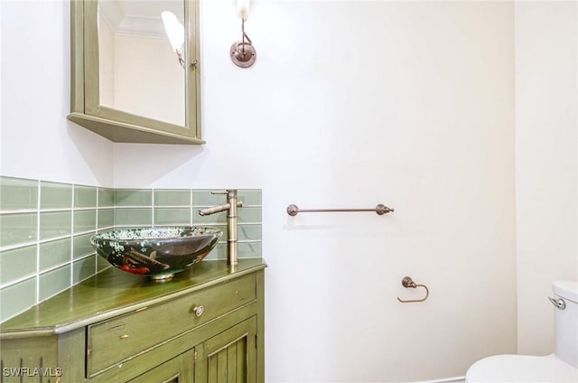 bathroom featuring decorative backsplash, vanity, and toilet