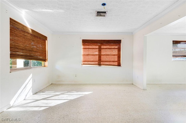 unfurnished room with a textured ceiling and ornamental molding