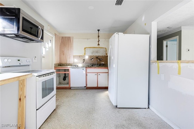 kitchen featuring backsplash, sink, and white appliances