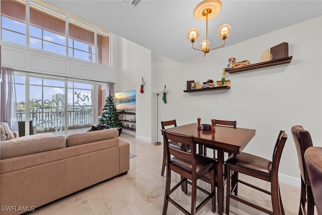 dining room featuring a water view and a chandelier