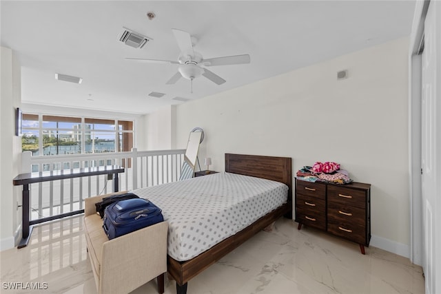 bedroom with ceiling fan and a closet