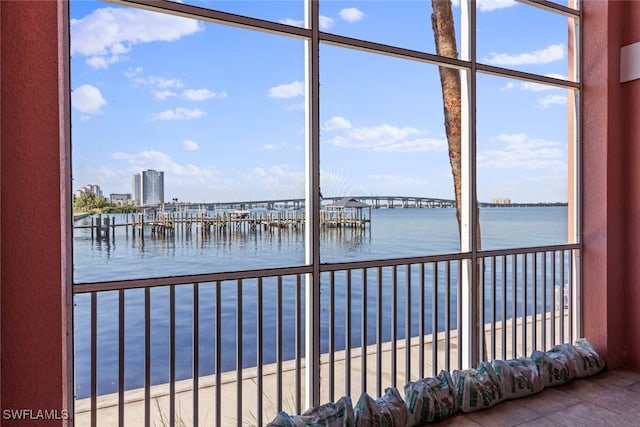 unfurnished sunroom featuring a water view