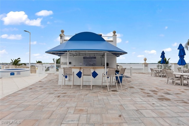 view of patio featuring an outdoor bar