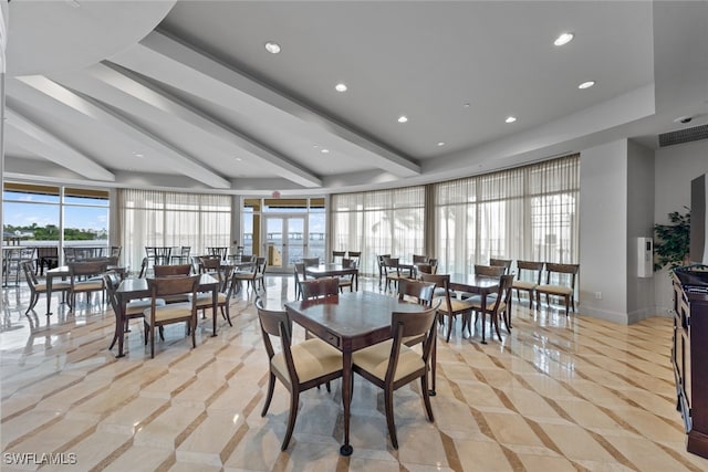 dining area featuring beamed ceiling