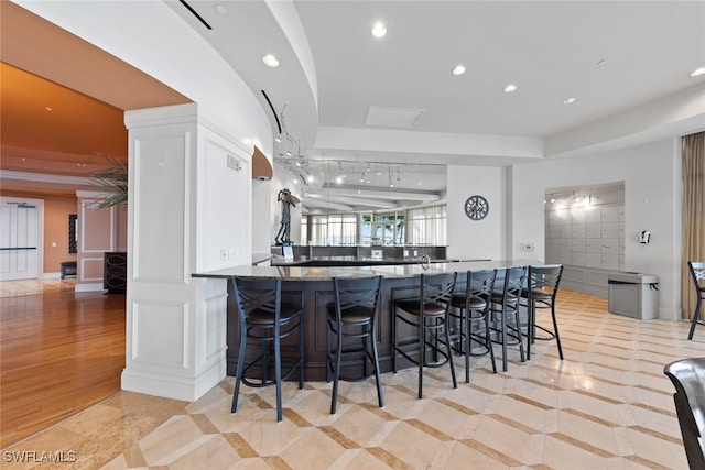 kitchen featuring kitchen peninsula, a kitchen breakfast bar, and light wood-type flooring