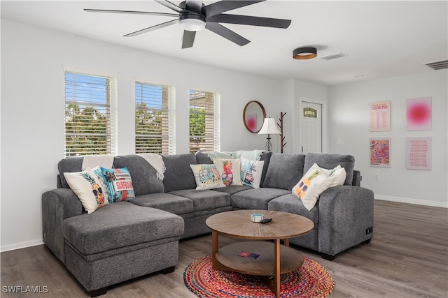 living room with plenty of natural light, ceiling fan, and wood-type flooring