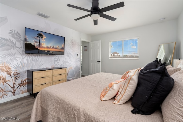 bedroom featuring ceiling fan and dark hardwood / wood-style flooring