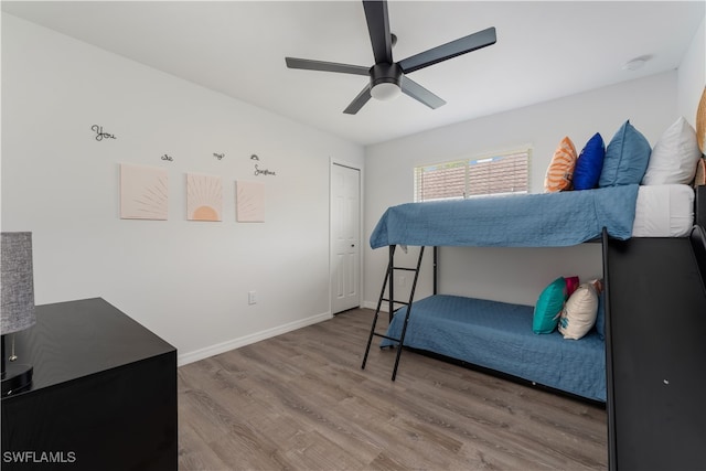 bedroom featuring hardwood / wood-style floors, a closet, and ceiling fan