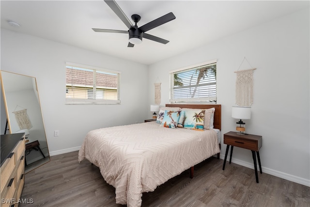 bedroom with dark hardwood / wood-style flooring and ceiling fan