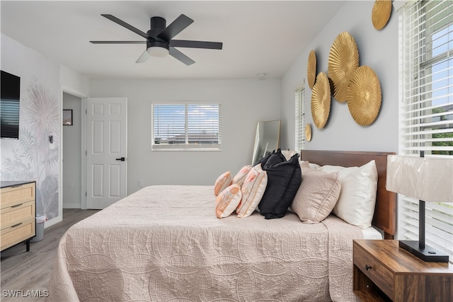 bedroom with hardwood / wood-style floors and ceiling fan