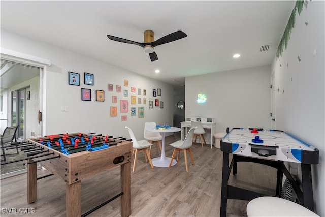 game room with ceiling fan and light wood-type flooring