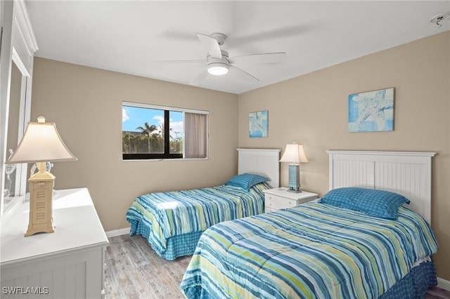 bedroom with light wood-type flooring and ceiling fan