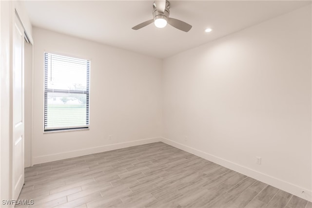 spare room with light hardwood / wood-style flooring and ceiling fan